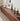 Made-to-order PrimePlank modern walnut TV console cabinet with a low profile design, featuring clean lines and ample storage space.