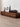Made-to-order Solid Made sculpted walnut wood TV console cabinet with sleek, modern design and natural wood grain finish.