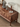 Made to order Epic Walnut Wood TV stand with geometric drawer fronts, featuring a sleek, modern design and natural wood finish.