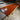 Africa Padauk wood dining table with live edge, Canyon brand, showcasing rich reddish-orange color and natural wood grain.