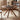 Made-to-order Earthy black walnut wood round table with four sturdy legs, showcasing natural wood grain and craftsmanship.