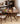 Made-to-order Earthy black walnut wood round table with four sturdy legs, showcasing natural wood grain and smooth finish.
