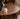 Made to order Earthy black walnut wood round table with four sturdy legs, showcasing natural wood grain and craftsmanship.