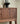 Made to order black walnut wood console table with sleek blinds design by Elexa, showcasing smooth finish and modern style.
