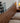 Waning crescent walnut wood bed by Grove Moon, made to order with a sleek, modern design and natural wood grain finish.