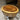 Rustic Elegance Serenade drum coffee table with round wooden surface and sturdy wooden legs, in a cozy living room setting.