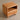 Artisan crafted round cherry wood bedside table with natural finish by Timbera, made to order for bedroom decor.