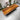 Solid American Walnut wood dining table by Whiz featuring a custom South African Walnut Monkey Pod tabletop with a natural wood grain finish.