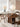 Made-to-order Wood Knot contemporary round table with three curved solid walnut wood legs and a smooth, polished surface.