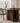 Made-to-order Wood Knot contemporary round table with three curved solid walnut wood legs and smooth tabletop.