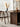 Made to order Wood Knot contemporary round table with three curved walnut wood legs and a smooth solid walnut top.