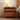 Made to order Woodhaven cherry wood nightstand with stylish glass drawers, featuring a sleek, modern design.